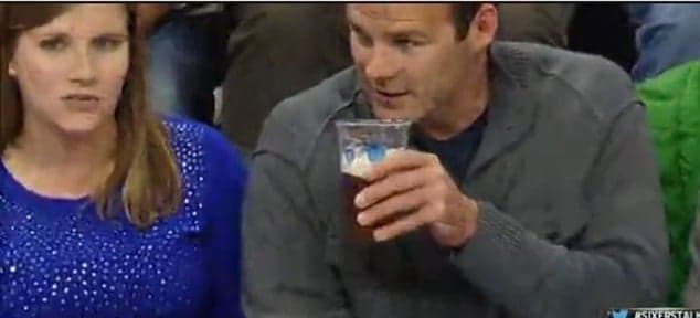 Errant pass leaves front-row NBA fan soaked in beer Errant pass leaves front-row NBA fan soaked in beer