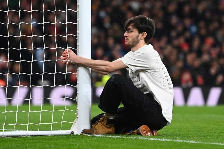 Environmental activist tries to handcuff himself to goal during Arsenal vs Liverpool clash Environmental activist tries to handcuff himself to goal during Arsenal vs Liverpool clash