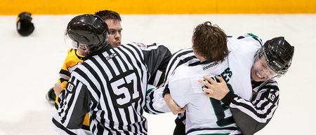 Throttled ice hockey player accidentally punches linesman in the face