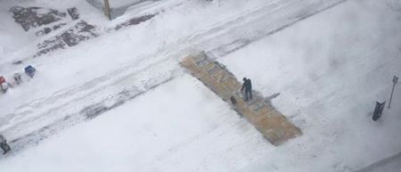 Pic: Mystery man with a shovel clears the finish line of the Boston Marathon after heavy snow