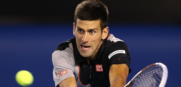 MELBOURNE, AUSTRALIA - JANUARY 21:  Novak Djokovic of Serbia plays a backhand in his quarterfinal match against Stanislas Wawrinka of Switzerland during the 2014 Australian Open at Melbourne Park on January 21, 2014 in Melbourne, Australia.  (Photo by Michael Dodge/Getty Images)