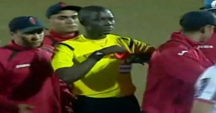 GIF: This referee is our new hero as he uses his red card to frighten off furious players