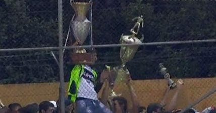 VIDEO: Fans break into trophy cabinet of rival team and throw the silverware onto the pitch