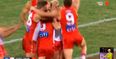 Colin O’Riordan’s Swans teammates swarm him as he kicks first goal for Sydney