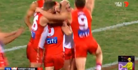 Colin O’Riordan’s Swans teammates swarm him as he kicks first goal for Sydney