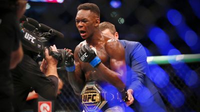 Israel Adesanya picks Robert Whittaker apart to become middleweight champion